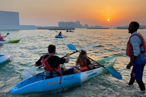 Kayakers launching at sunset near the Louvre Abu Dhabi Saadiyat Island