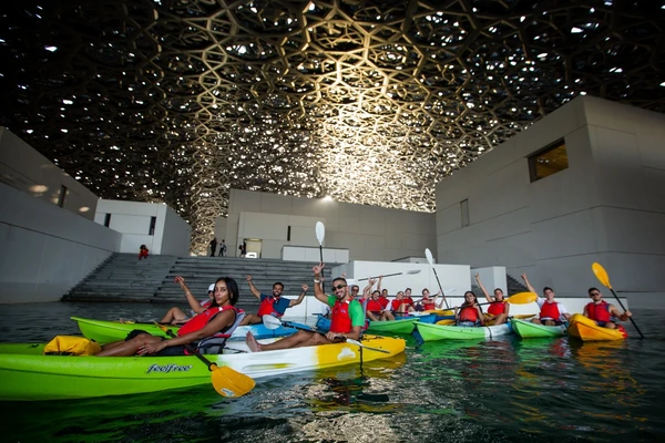 Group kayaking under the Louvre Abu Dhabi dome