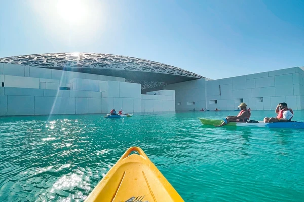 Kayaker POV view looking up at the Louvre Abu Dhabi dome from the water