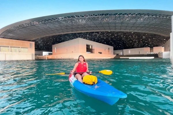 Solo kayaker in front of the Louvre Abu Dhabi exterior