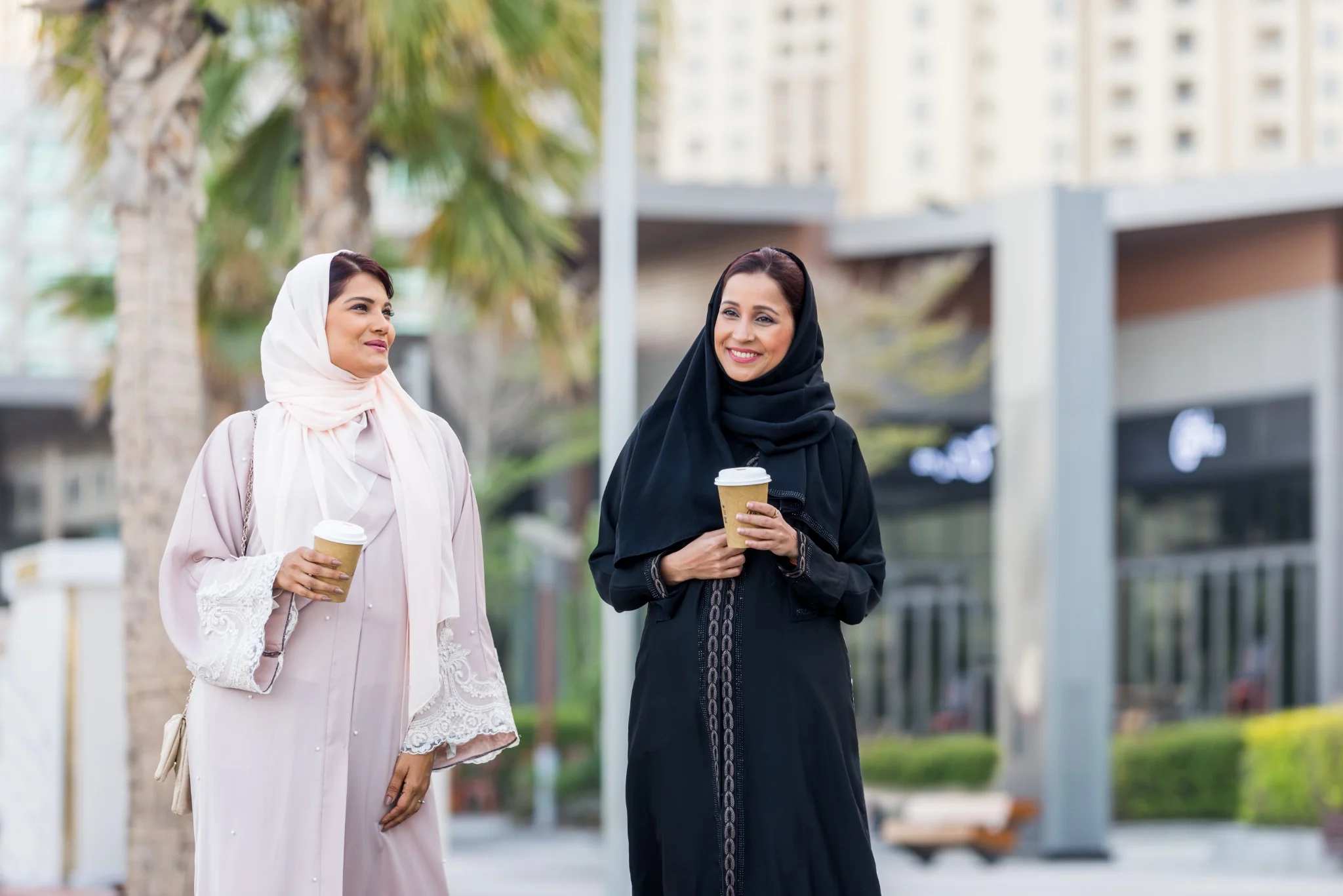 Two women enjoying coffee during an Abu Dhabi city break