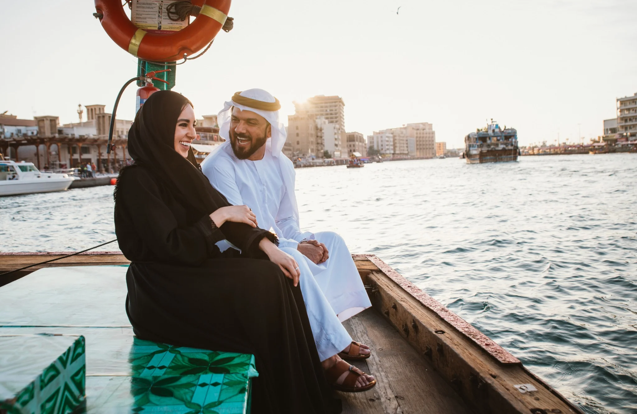 Guests enjoying drinks and skyline views on an Abu Dhabi cruise