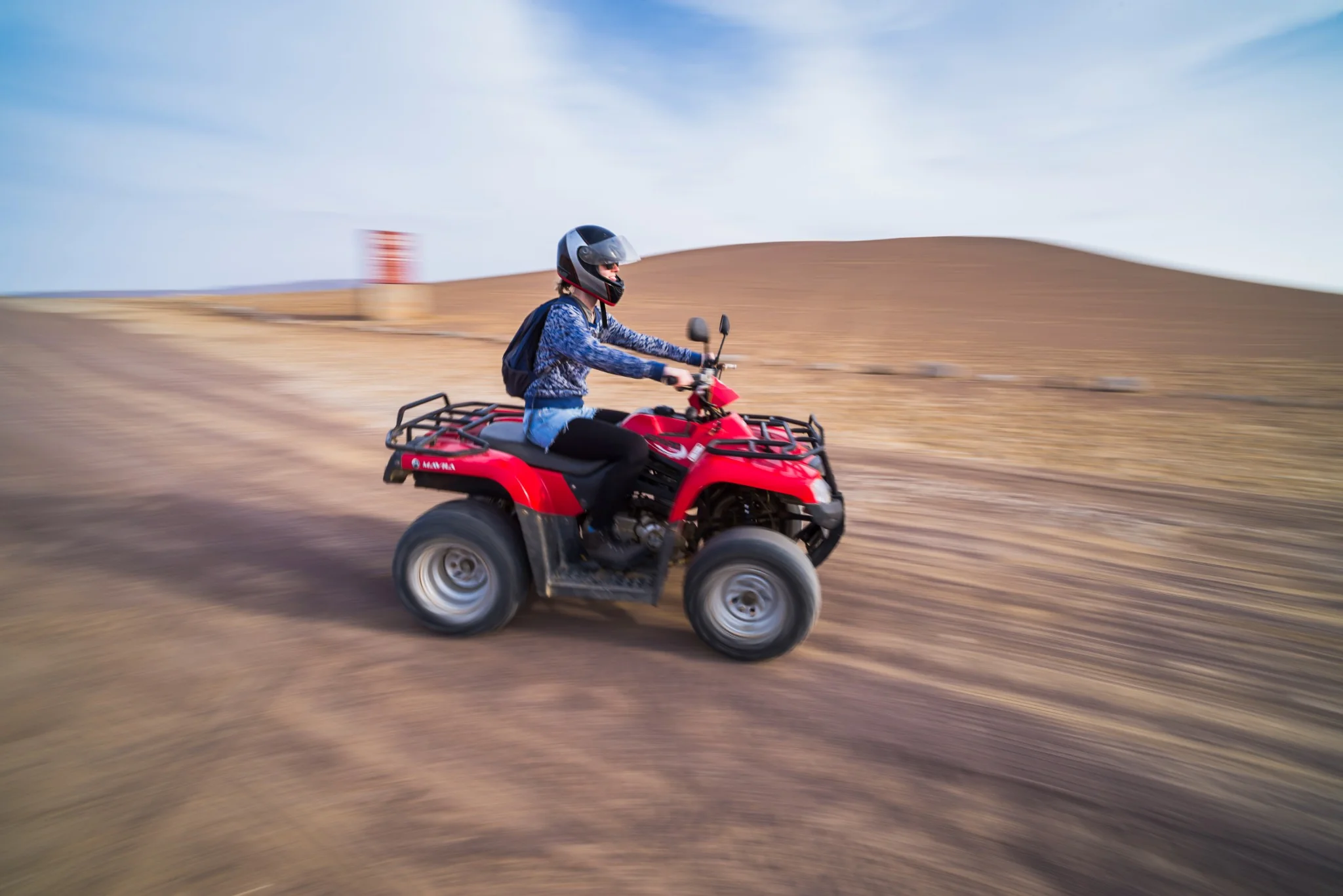Two quad bike riders on open desert terrain in Abu Dhabi