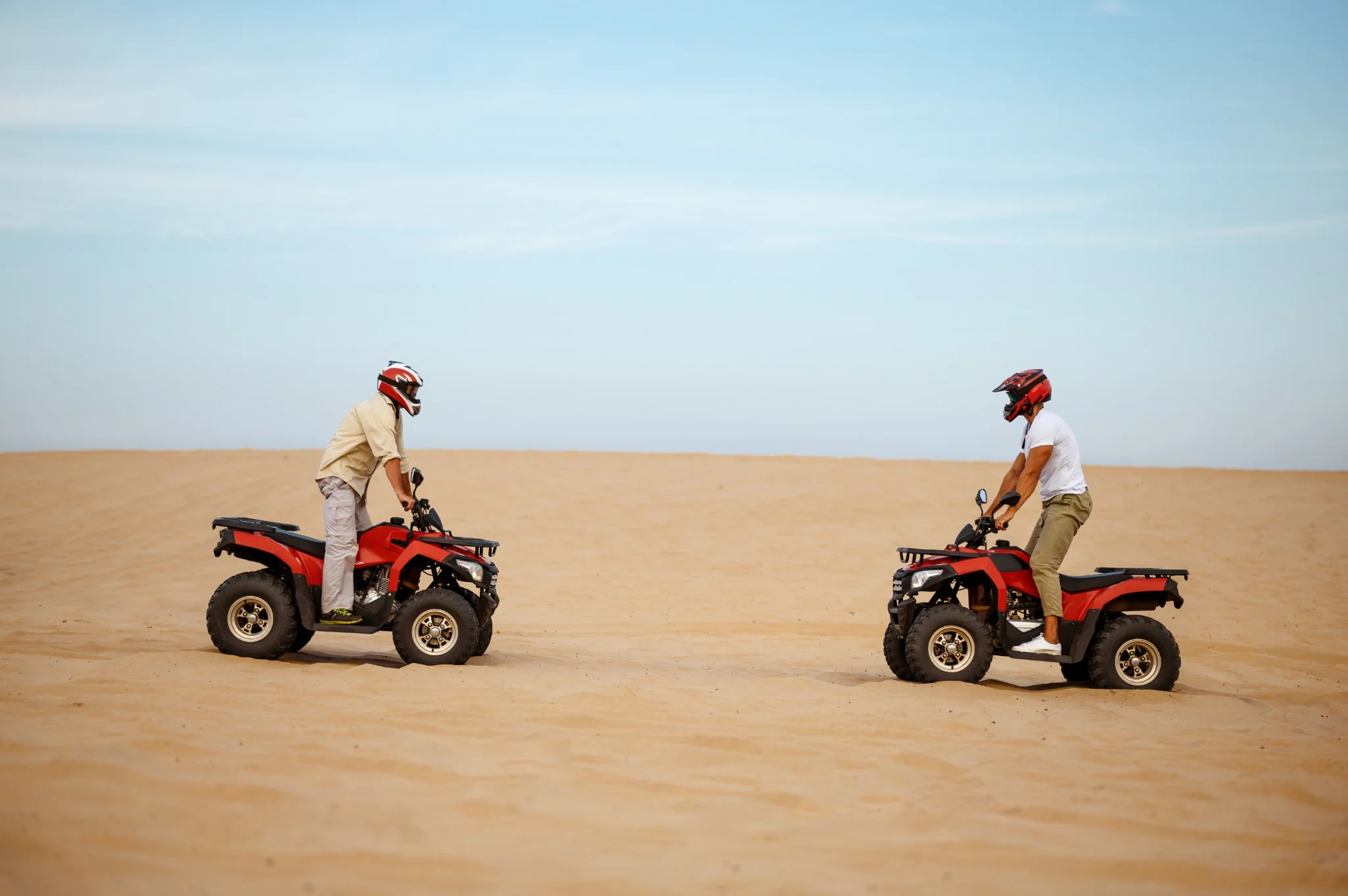 Quad bike rider crossing desert tracks in Abu Dhabi