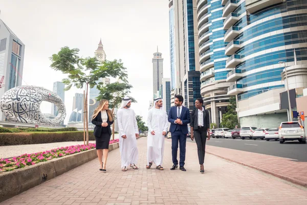 Business travellers and Emirati hosts together near the Museum of the Future during a Dubai business and investment tour