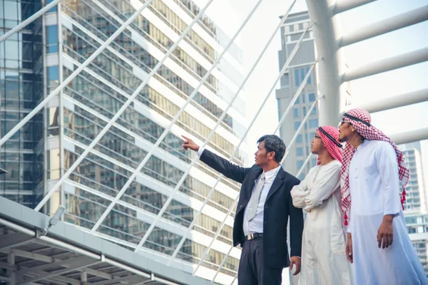 International business visitors speaking with Emirati hosts in central Dubai during a private investment orientation tour