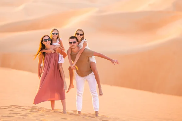 Family enjoying the golden Liwa dunes during a private day tour from Abu Dhabi to the Empty Quarter