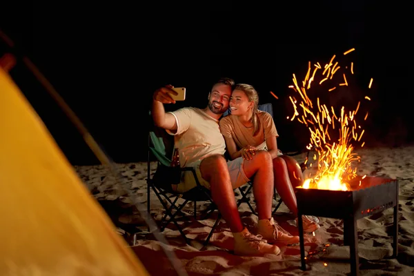 Emirati couple enjoying Arabic coffee on the dunes during an Abu Dhabi desert safari
