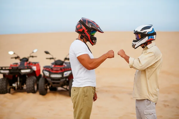 Emirati couple relaxing with Arabic coffee during a private desert safari near Abu Dhabi