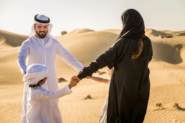 Local guide pointing across the dunes during a private Abu Dhabi desert safari