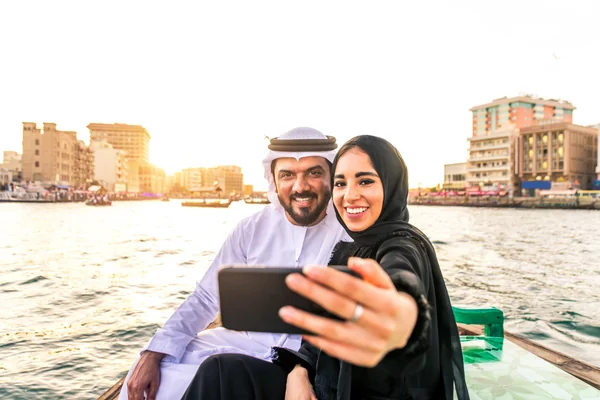 Emirati couple sightseeing from a traditional boat during a UAE explorer holiday